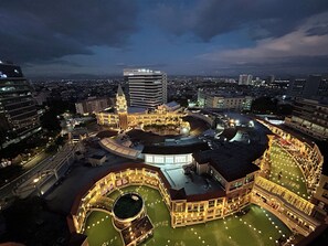 A historic building with a central courtyard, surrounded by modern high-rise buildings. - VenizLex  (Taguig)