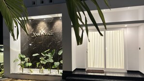 A modern building with a marble facade and a sign reading "ANCHORAGE". - Private Beach Front Villa (Thalikulam)