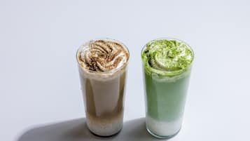 Two beverages in clear glasses.