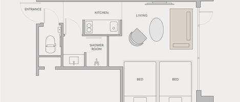 A floor plan of a hotel room with an entrance, kitchen, shower room, two beds, and a living area.