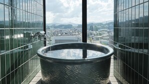 A modern indoor pool area with a large circular pool, glass walls, and a city view. - FAV LUX HIDATAKAYAMA (Takayama)