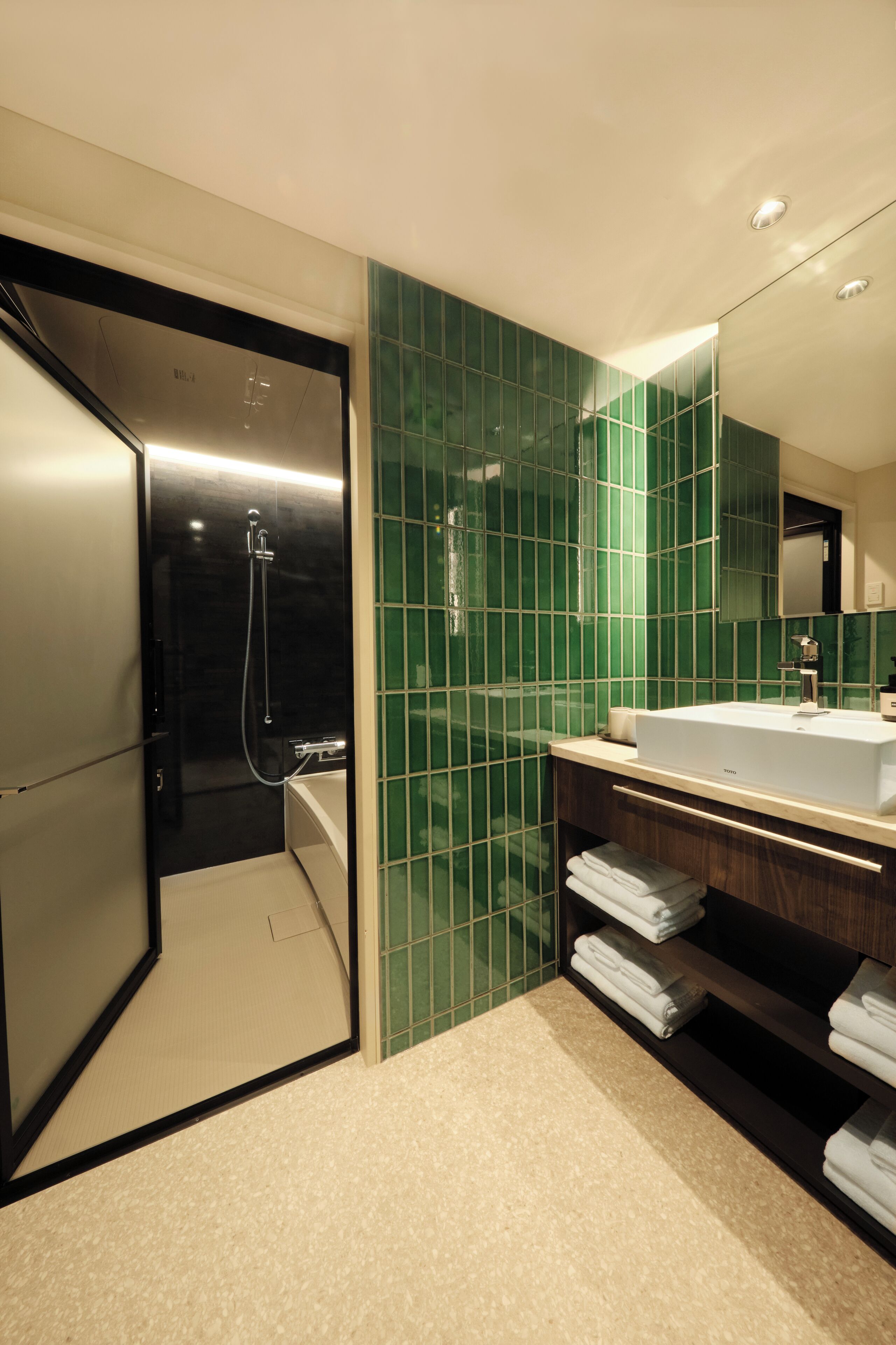 A modern bathroom with a shower, a sink, and a mirror.