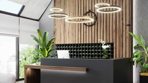 A modern reception desk with a wooden panel backdrop, a black grid-patterned shelf, and a glass partition. - crestpark apartments (Nairobi)