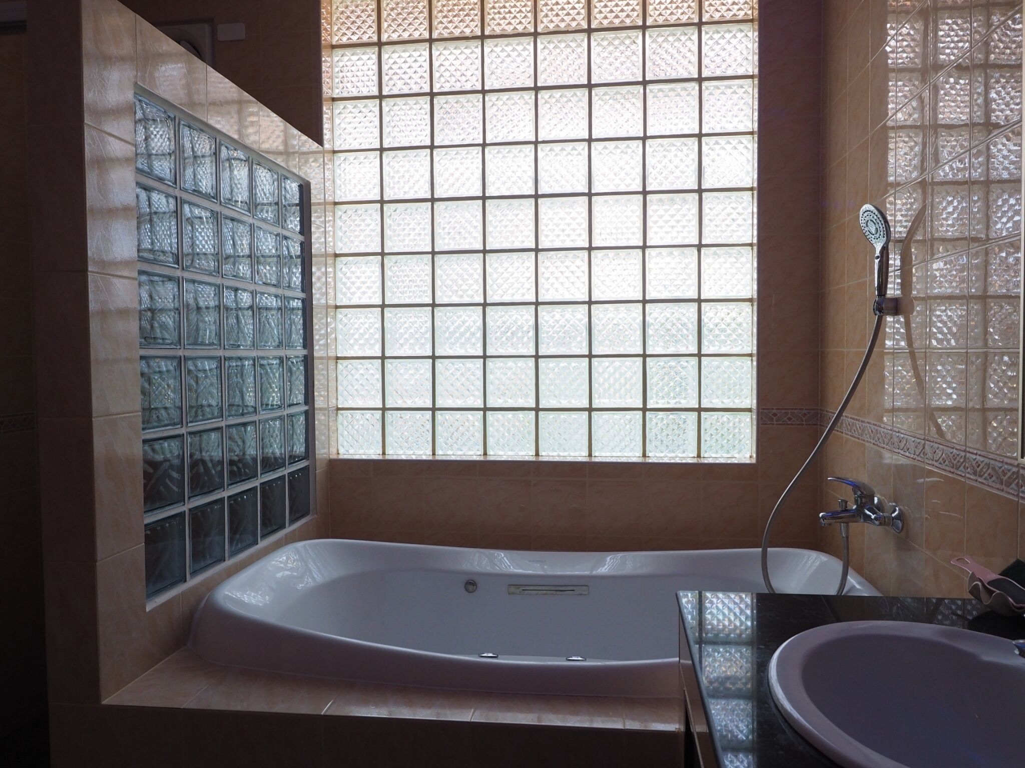 Une salle de bain avec une grande baignoire, une douche à parois de verre et un lavabo.