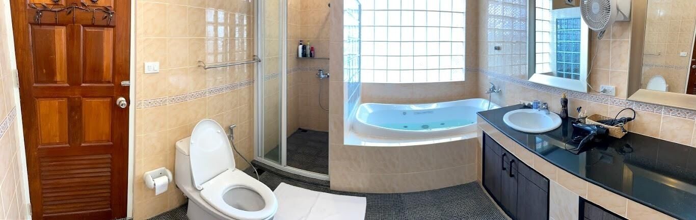 A bathroom with a toilet, a shower, a bathtub, and a sink.