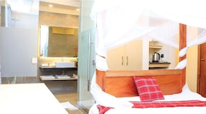 A hotel room with a bed, a bathroom, and a kitchenette. - River Lumi Resort - Taveta (Chala)