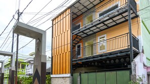 A multi-story residential building with a balcony on the second floor. - Graha Asri Syariah (Sidoarjo)