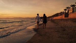 A couple walking on a beach with a sunset in the background. - Break For Two (Agropoli)