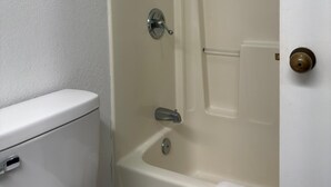 A bathroom with a toilet, a bathtub, and a shower. - Motel 6 Fancy Gap, VA (Fancy Gap)