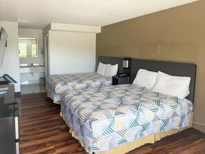 A hotel room with two beds, a desk, and a bathroom. - Motel 6 Fancy Gap, VA (Fancy Gap)