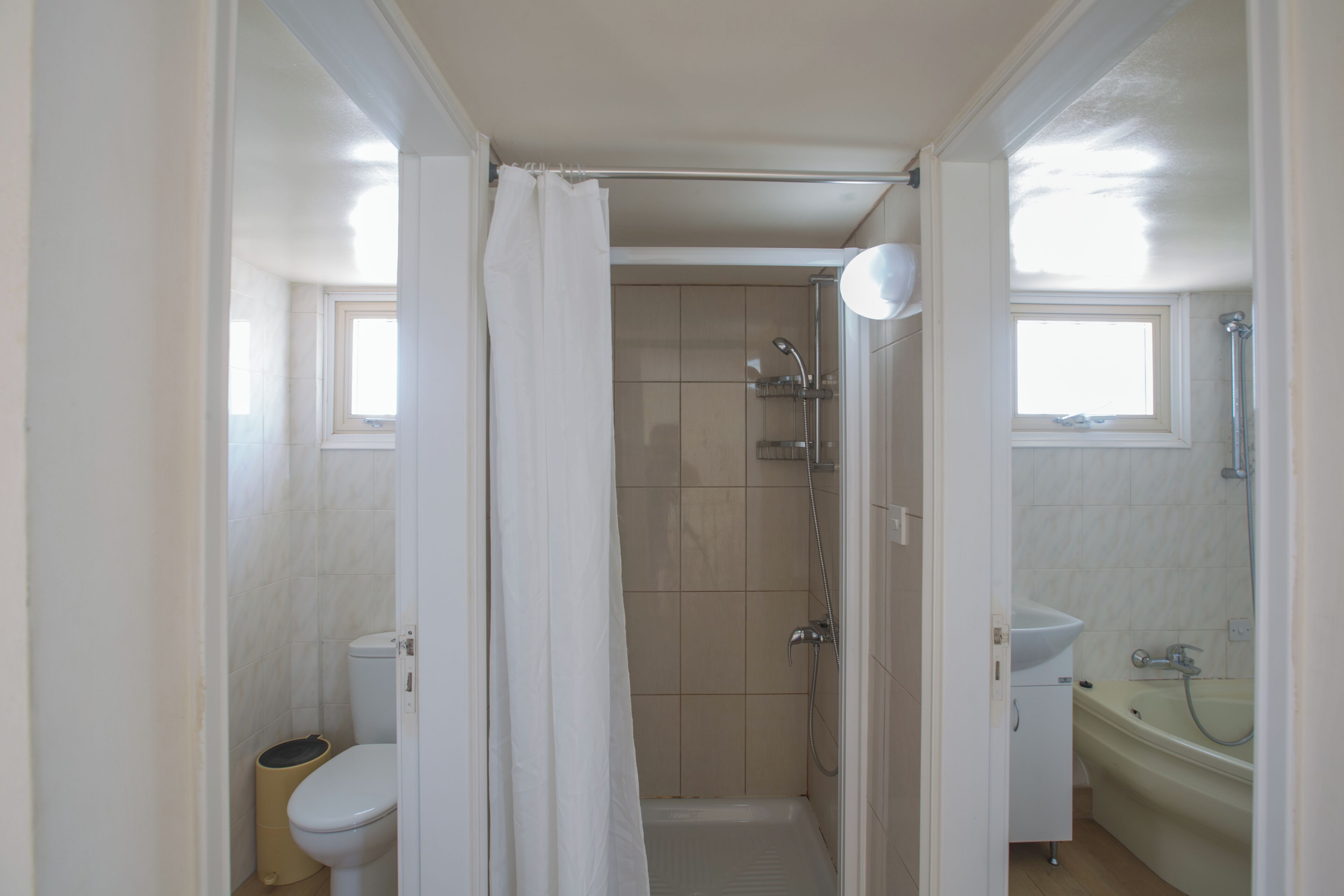 A bathroom with a shower, toilet, and sink.