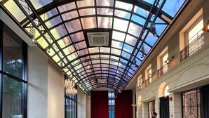 A spacious lobby with a glass ceiling, a reception desk, and a seating area. - Luxurious Suites in Kl Centre (Kuala Lumpur)