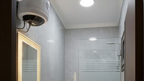 A modern bathroom with a white sink, toilet, and shower. - Luxurious Chalet With Sea Views in Port Said, Egypt (Al-Manasrah)