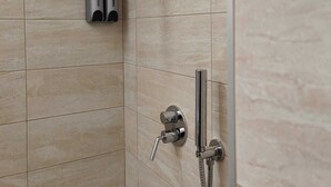 A shower area with a handheld showerhead and a wall-mounted body spray. - Room-central Room With Balcony And Amazi (Cefalù)