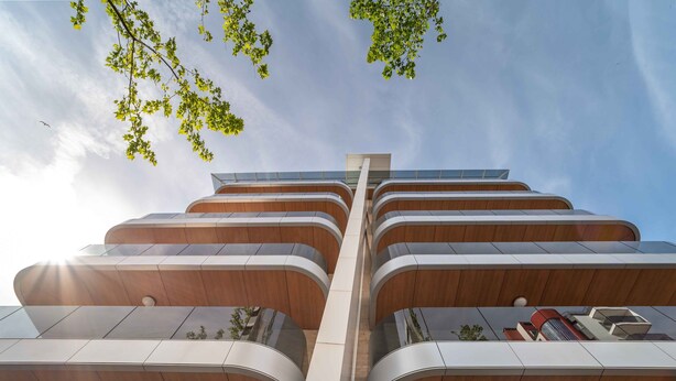 A modern building with multiple balconies and a central vertical structure. - Elegant Residenza Monica Two Bedroom C6 Sleeps 6 (Lignano Sabbiadoro)