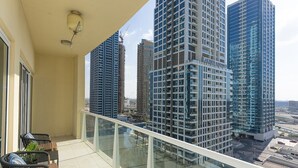A balcony with a view of high-rise buildings, including a Lakeside Residence. - Homesgetaway - JLT Lake Views 1BR (Dubai)
