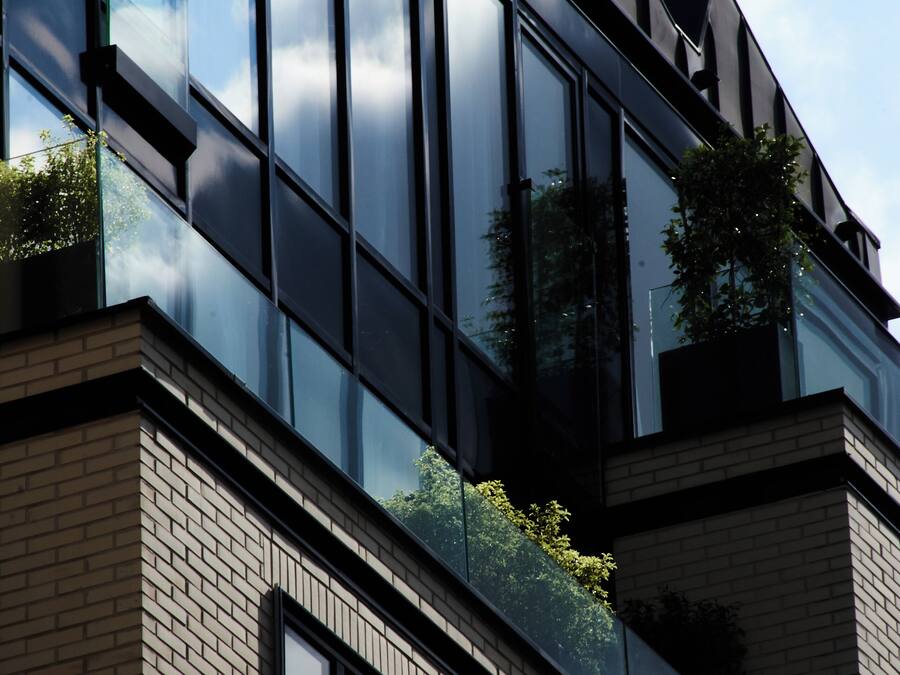 A modern building with large glass windows and a brick facade.