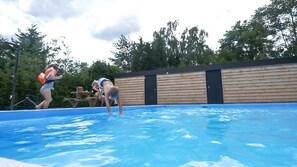 Seasonal outdoor pool, open 9:00 AM to 9:00 PM, pool umbrellas