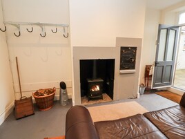 A cozy room with a fireplace, a seating area, and a door leading outside.
