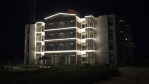 A multi-story hotel with a flat roof and a 'HOTEL' sign at the top. - Hotel Millennium Plaza (Jamnagar)
