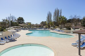 Relax by the resort's large oval-shaped pool surrounded by lounge chairs and umbrellas.