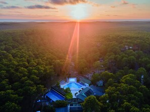 An aerial view of a resort with a swimming pool, surrounded by dense forest. - Résidence les Cavales (Carcans)