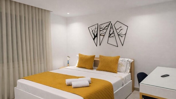 A hotel room with a bed, a desk, and a chair. - Lovely 1-bed Apartment in Lac1 Tunis (Tunis)