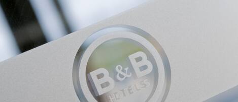 A close-up of a B&B hotel sign with a circular logo.