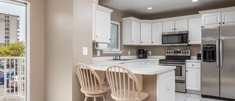 Fridge, microwave, coffee/tea maker, cookware/dishes/utensils