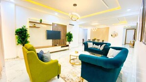 Suite de lujo | Área de sala de estar | Smart TV de 50 pulgadas con canales por cable y televisión 
