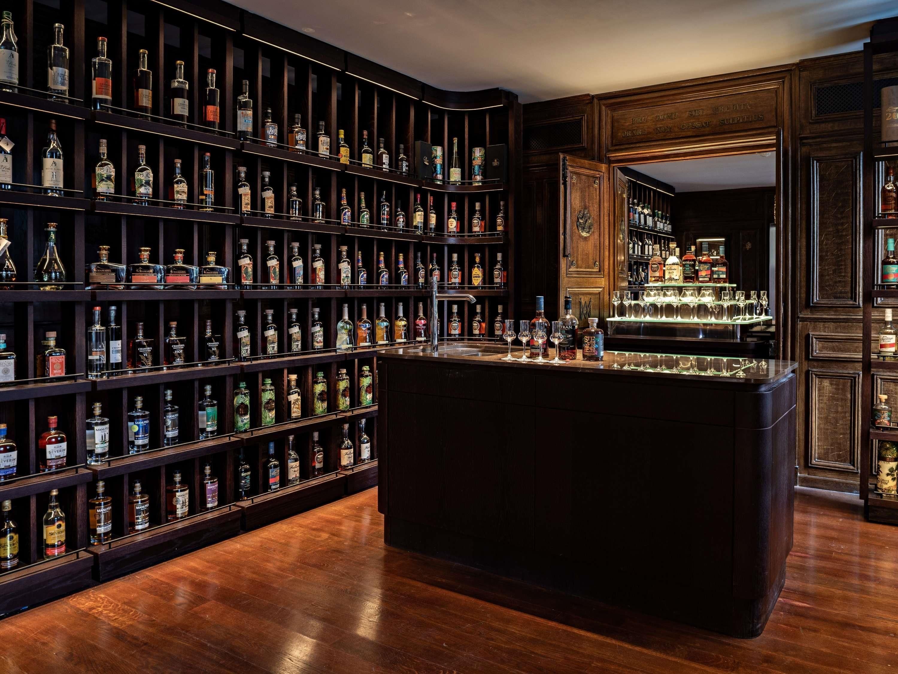 A bar area with shelves of liquor bottles and glasses.
