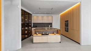 A modern kitchen with a central island, built-in appliances, and a sleek design. - RDR234 - Amazing modern villa located minutes from beach (Marbella)