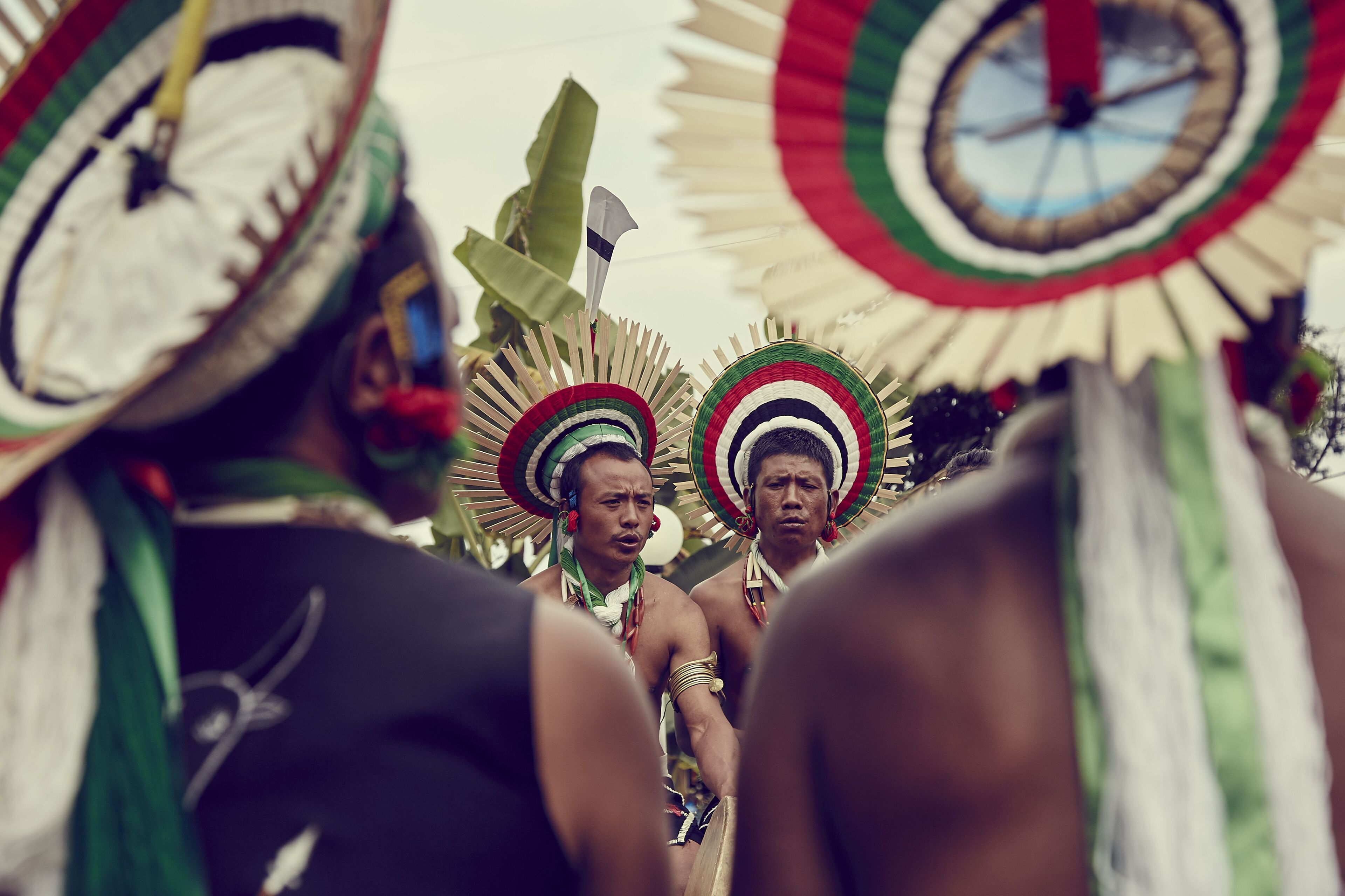 A group of people wearing traditional headdresses with intricate designs.