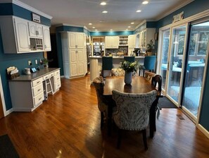Enjoy meals in the kitchen with a central island, dining area, and large window offering a view of the outdoors.