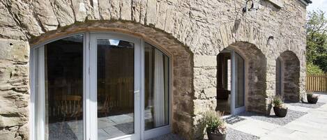 Classic architecture meets modern charm in this beautifully maintained outdoor space with large arched windows and doors.