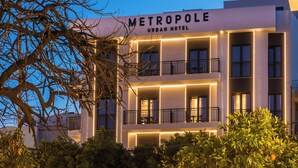 Ein modernes Stadthotel mit mehreren Balkonen und beleuchteten Eingängen.