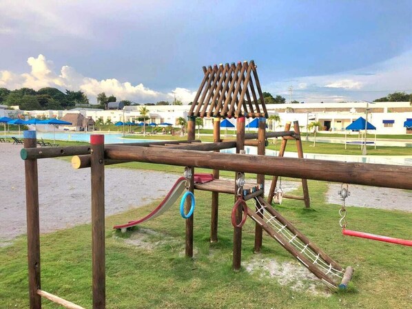 A playground with a slide, climbing structures, and a swing set. - Villa for 8 – Sand-Entry Pool, Terrace & Fast WiFi (Río Hato)