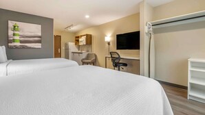 A hotel room with two beds, a desk with a chair, a television, and a kitchen area. - Extended Stay America Premier Suites - San Diego - San Marcos (San Marcos)