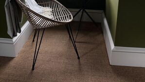 A corner room with a view of a street, a wicker chair, and a small round table. - Sugar Boat (Helensburgh)