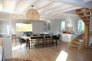 A spacious kitchen with a dining area, wooden flooring, and a staircase leading to an upper level. - Superb Belliloise house - high standing (Bangor)