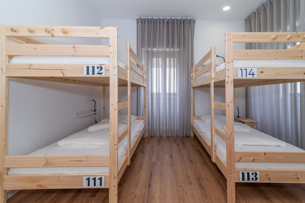 A room with four bunk beds, each labeled with a number.