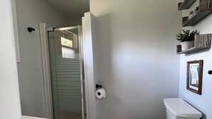 A bathroom with a toilet, a shower, and a marble floor. - Private getaway on Lower Buckhorn Lake (Trent Lakes)