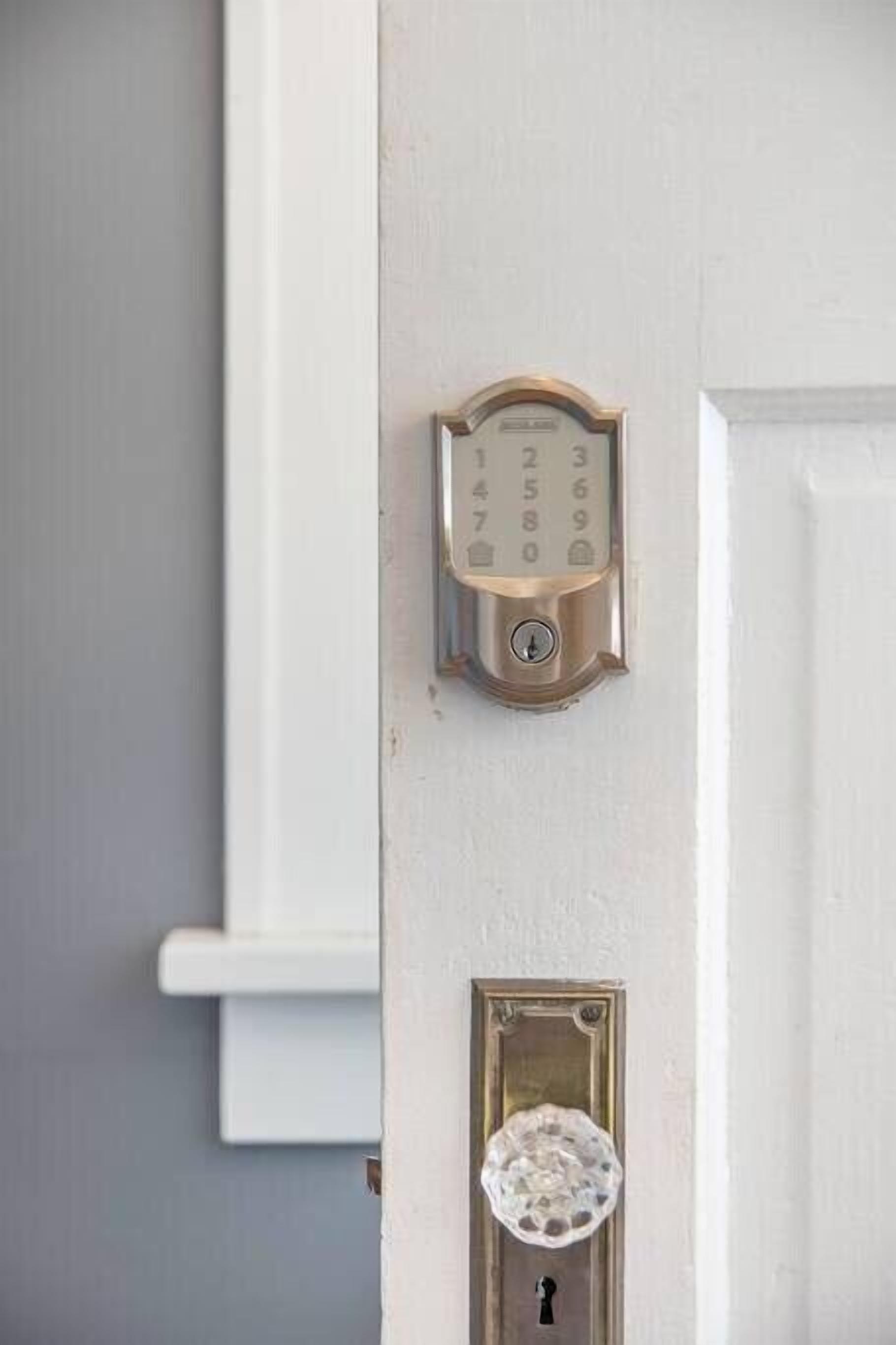 A door with a numeric keypad lock and a keyhole below it.