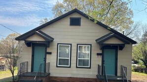 A single-story house with a gabled roof, two front doors, and a small porch with steps. - Extended Stay NE Hickory 1 Bedroom 1 Bath Workspace, Washer Dryer, duplex apt. (Hickory)