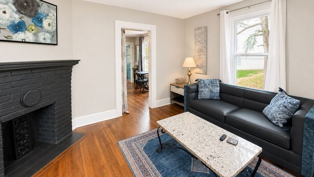 A living room with a fireplace, a sofa, a coffee table, and a rug. - Extended Stay NE Hickory 1 Bedroom 1 Bath Workspace, Washer Dryer, duplex apt. (Hickory)