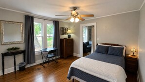 A bedroom with a bed, a desk, a chair, a dresser, a mirror, and a ceiling fan. - Extended Stay NE Hickory 1 Bedroom 1 Bath Workspace, Washer Dryer, duplex apt. (Hickory)