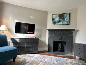 Relax in this stylish living room with a flat-screen TV, fireplace, and comfortable seating area.