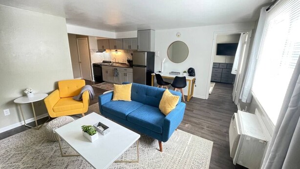 A modern apartment with a living room, kitchen, and dining area. - Twin Oaks Extended Stay One Bedroom - 2817 Apt 6 (Syracuse)