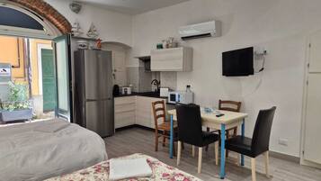 Deluxe Apartment | Private kitchen | Full-size fridge, dining tables