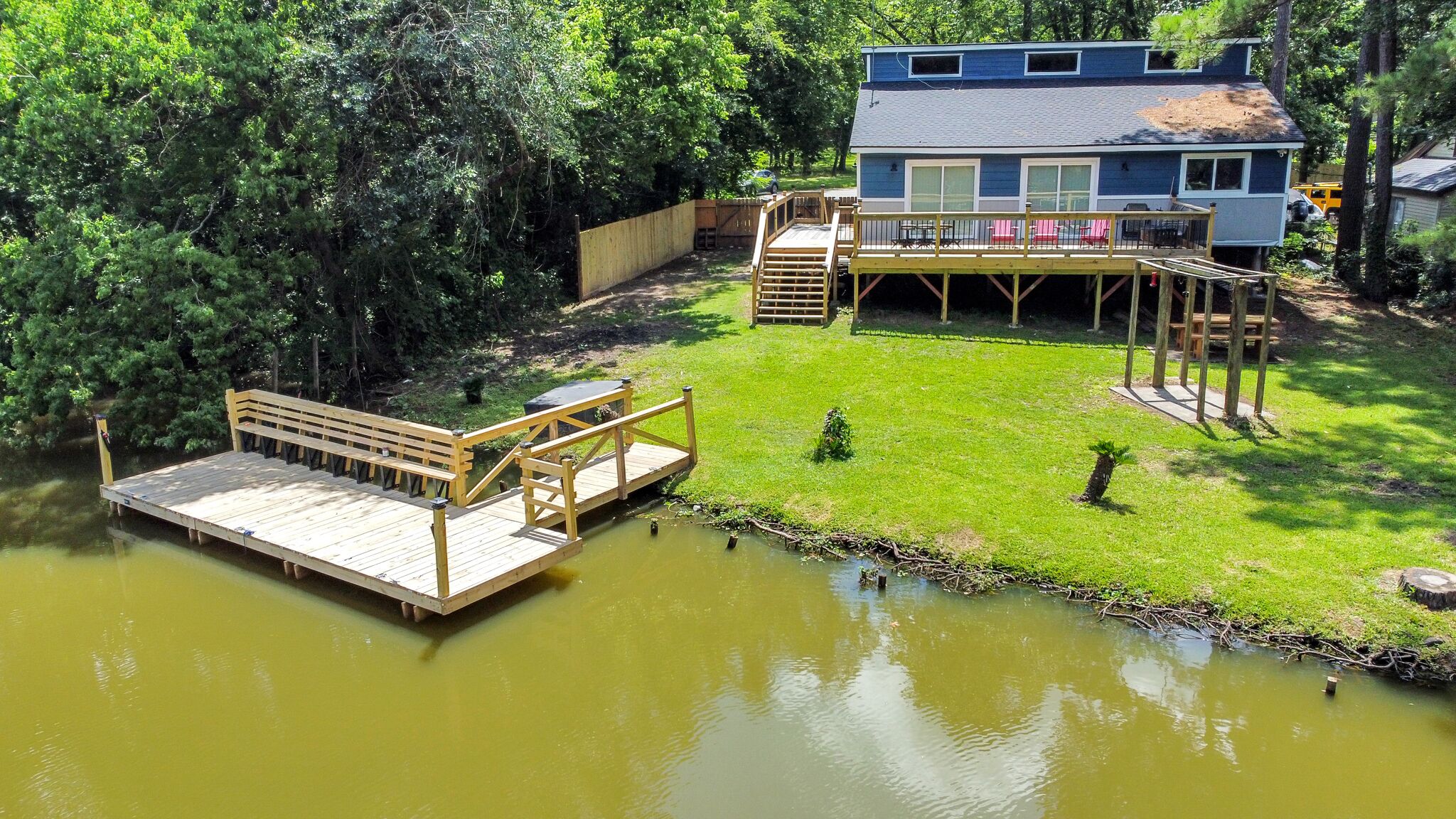 Waterfront house with a large deck and dock for boat or fishing